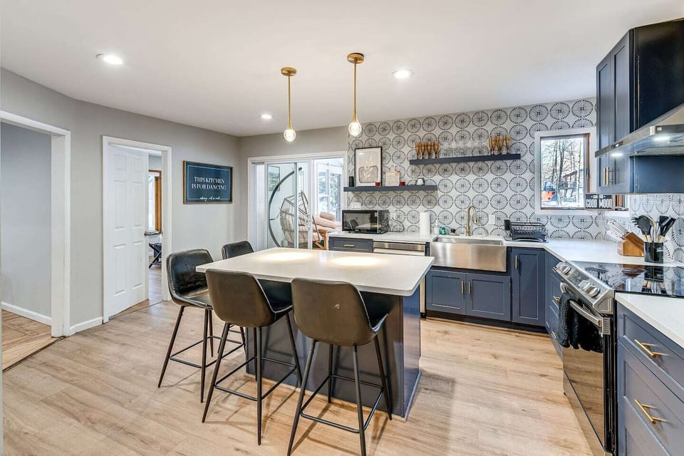 Prepare delicious meals and gather around the island for lively conversations and quick bites in this modern, fully-equipped kitchen.
