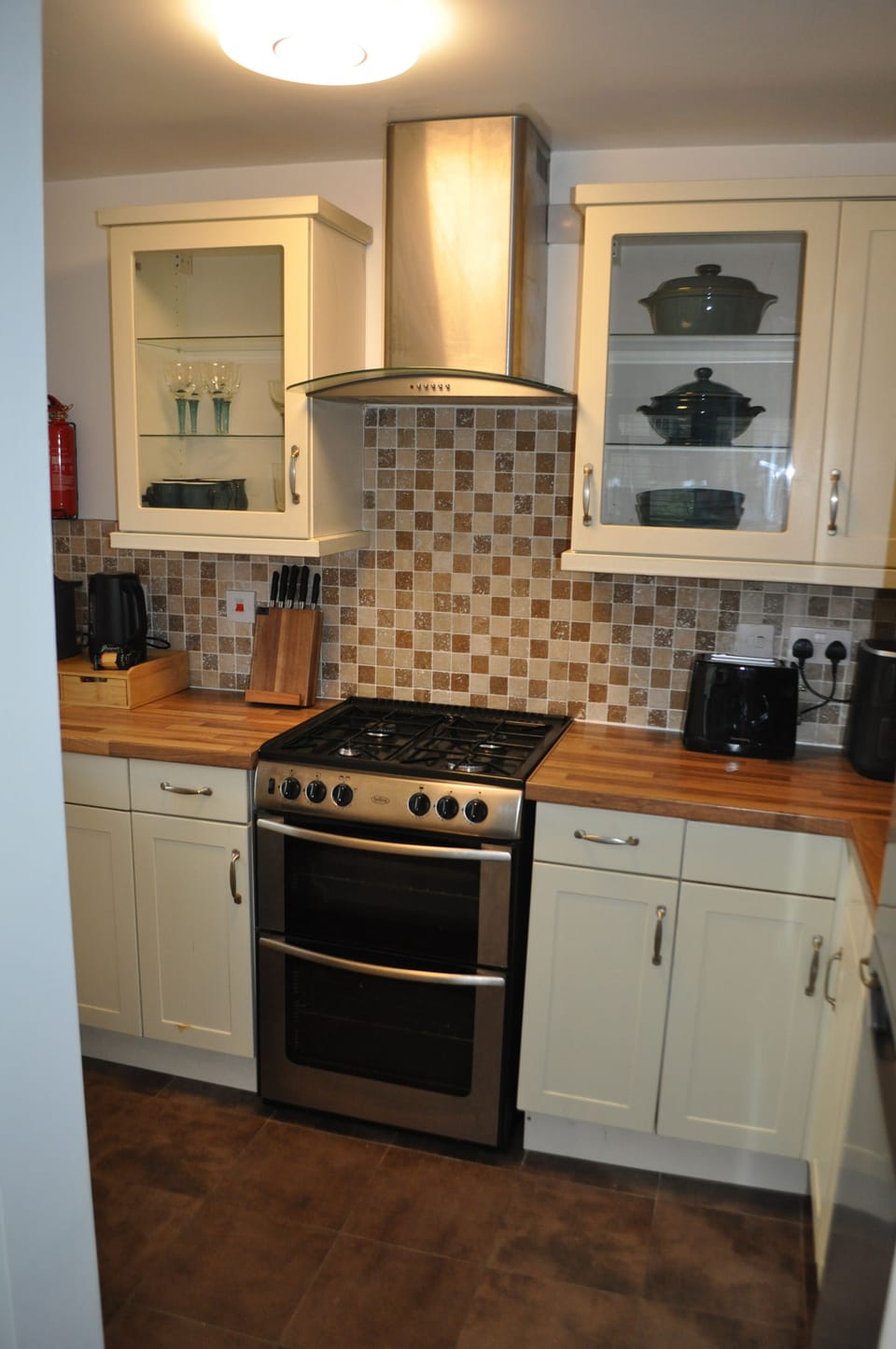 Fully fitted kitchen with oven and hob