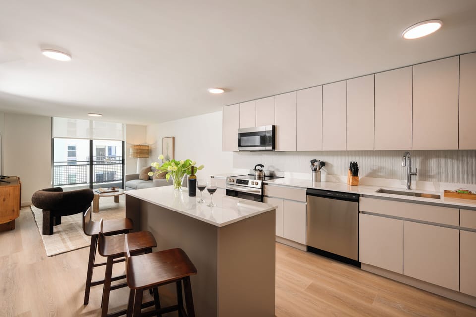 The culinary heart features high-end stainless steel appliances and quartz countertops.