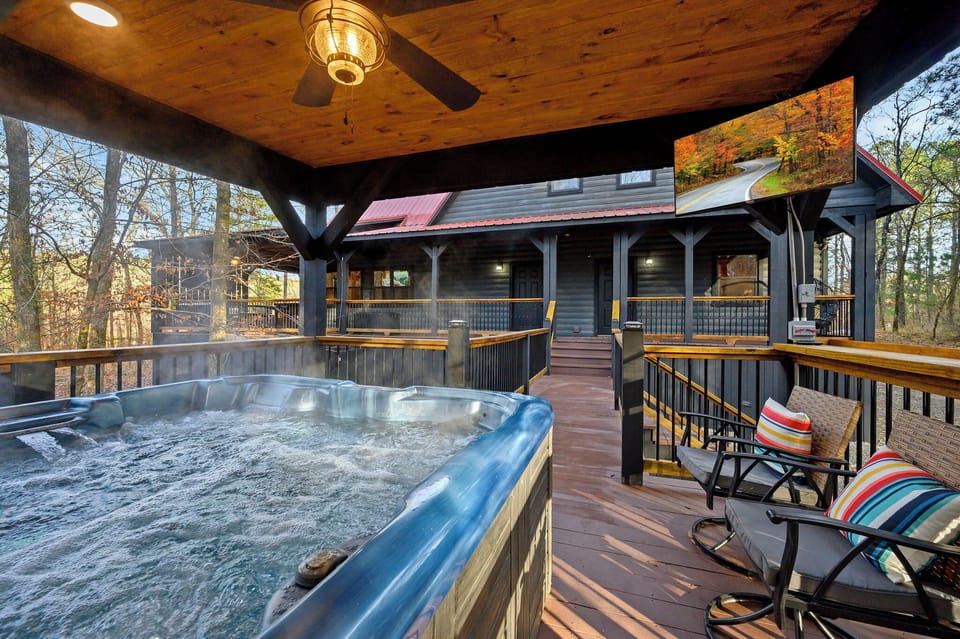 Private hot tub deck with smart TV and additional seating.