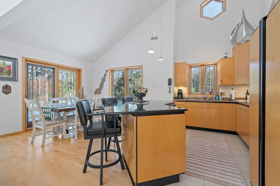Gather around your spacious kitchen island for morning coffee while natural light streams through forest views—the perfect spot for memorable meals.