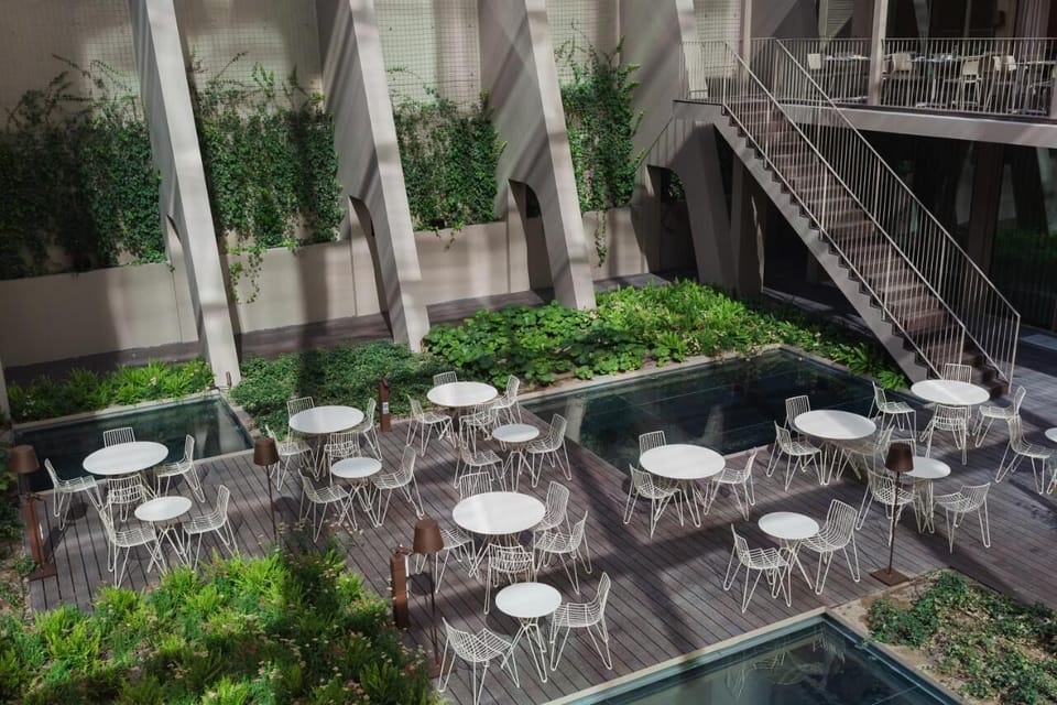 Escape into a lush courtyard oasis beside tranquil reflecting pools.