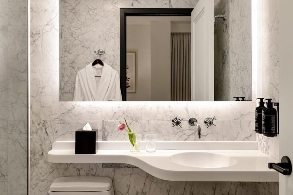 Refresh at a sleek, backlit vanity with spa serenity.