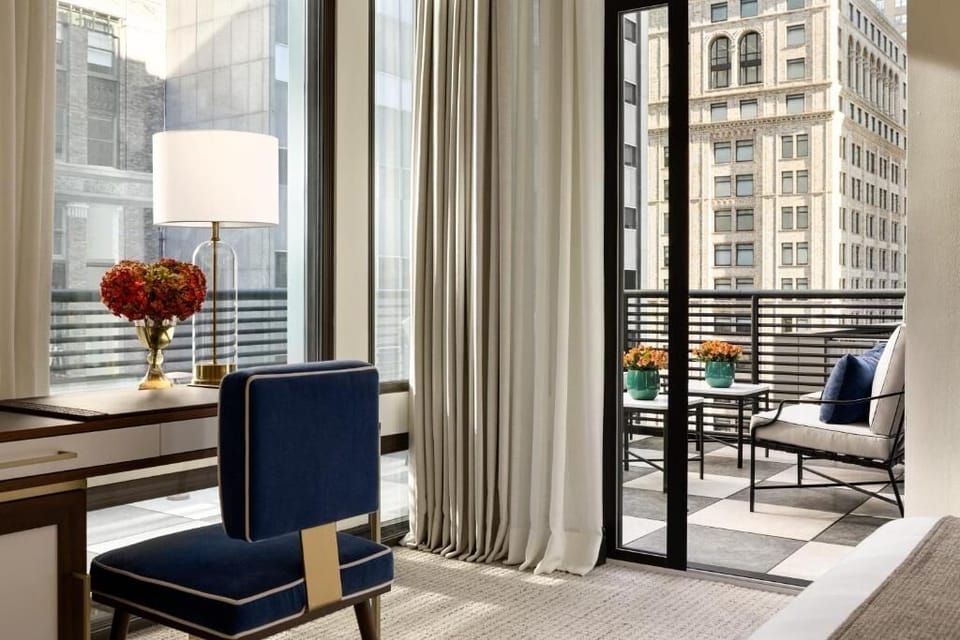 Settle in with a stylish workspace and sunny balcony doors.