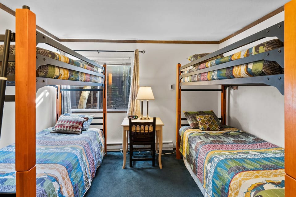 Cozy bunk room with two twin bunk beds and trundles.