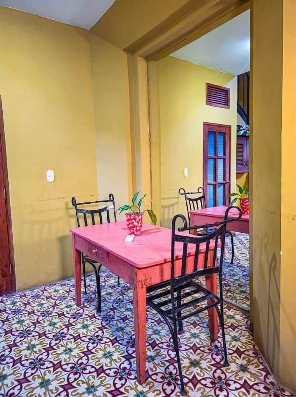 Interior dining nook with antique cement-tile floors at a colonial home rental in Granada, Nicaragua