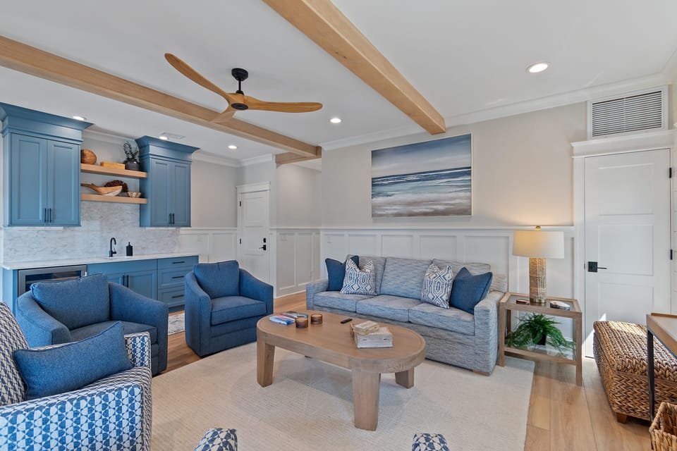 Stitting room on second floor with queen sleeper sofa, wet bar and 65" smart TV.