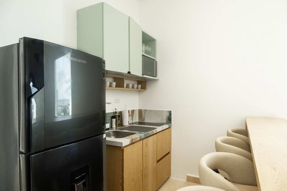 Kitchen area with refrigerator and cabinets.
