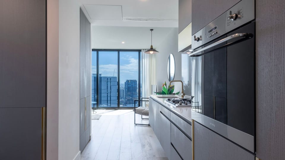 Sleek kitchen corridor leading to dining and living space