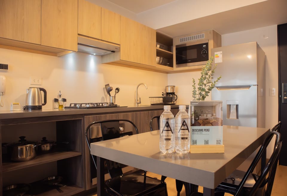 Fully equipped kitchen with wooden cabinets and essential appliances.