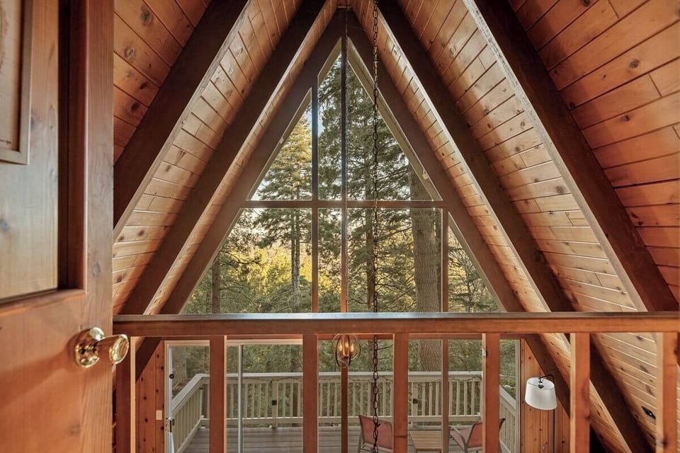 Iconic A-frame loft view overlooking the great room and forest beyond