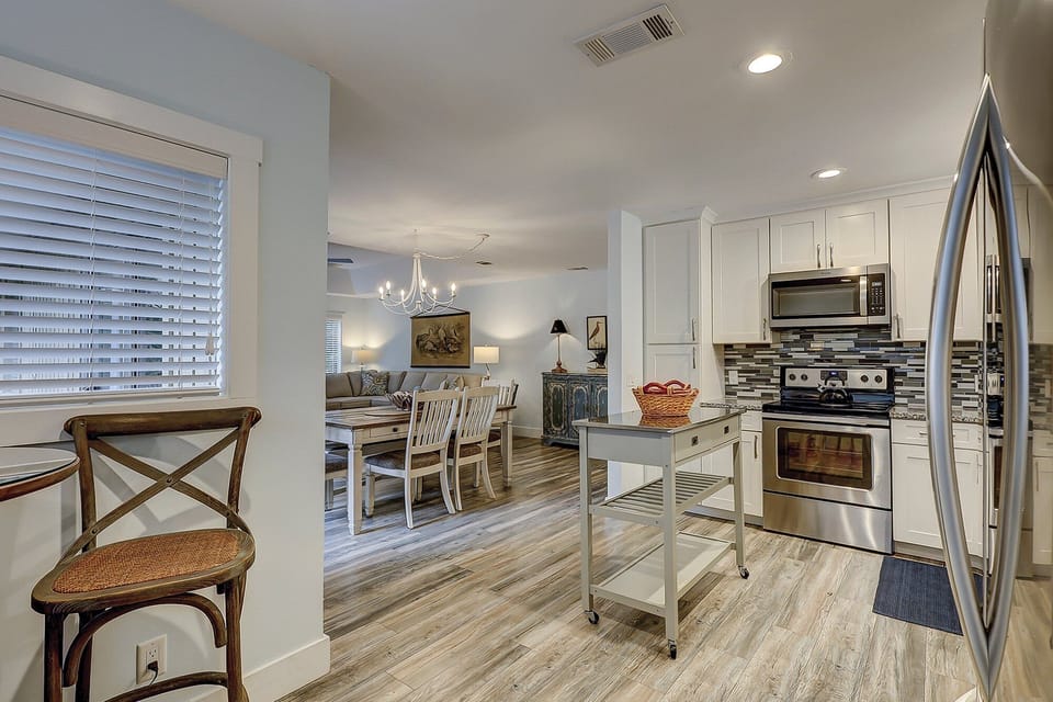 Fully stocked kitchen with all stainless steel appliances.