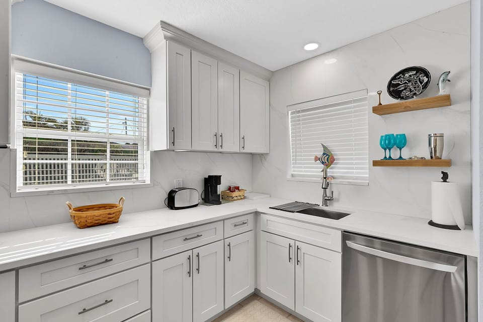 Fully equipped kitchen with fridge, oven, stove, microwave, toaster, coffee maker, basic cooking utensils, dishware, and more!