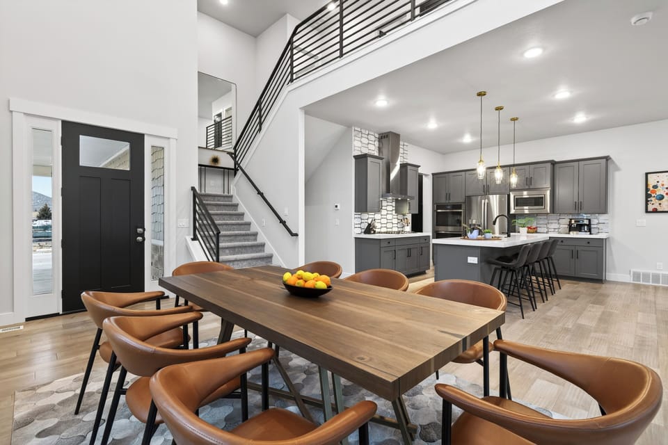 Sun-filled dining area with vaulted ceilings, oversized windows, and seamless flow into the living room—ideal for gathering everyone together after a day in Park City.