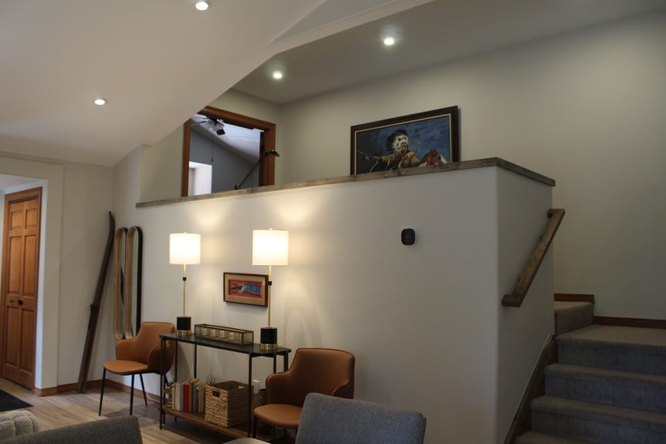 Living Room - At the top of the stairs, you’ll find a queen bedroom, a guest room with a queen bed and twin bunk beds. These rooms share a full bathroom.