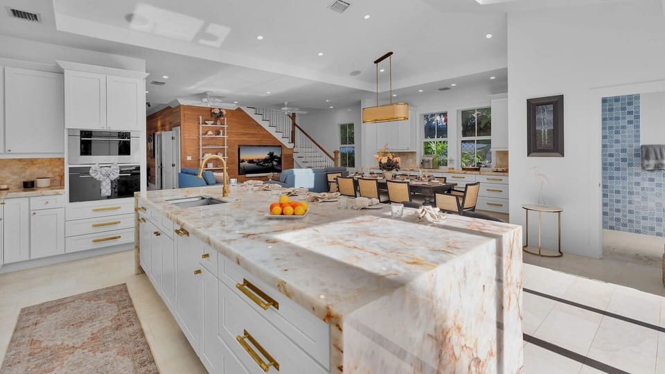 Your gourmet kitchen features marble countertops, high-end appliances, and an open layout perfect for cooking and entertaining.