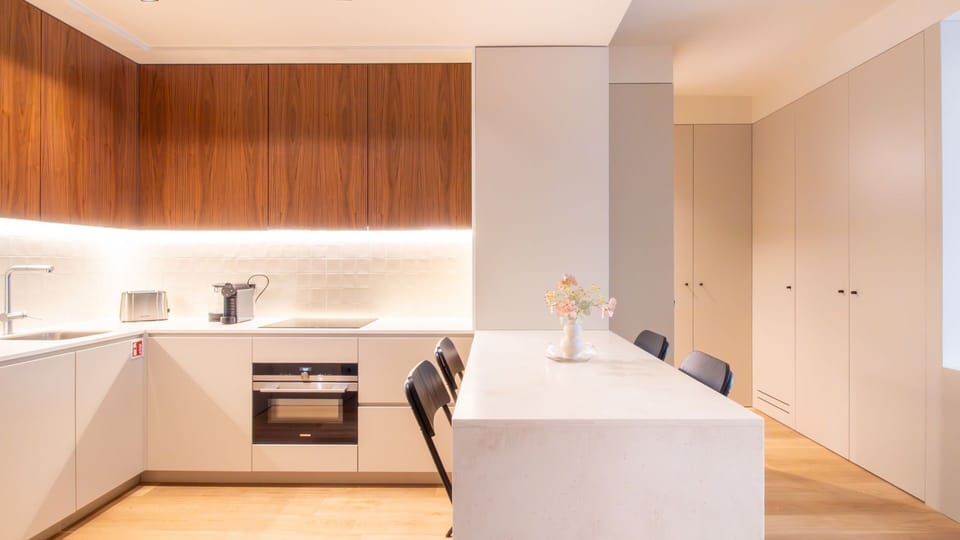 Fully equipped designer kitchen with sleek cabinetry, cooktop, and espresso machine; perfect for morning routines. #CookInStyle #PortoKitchen #CoffeeCorner
