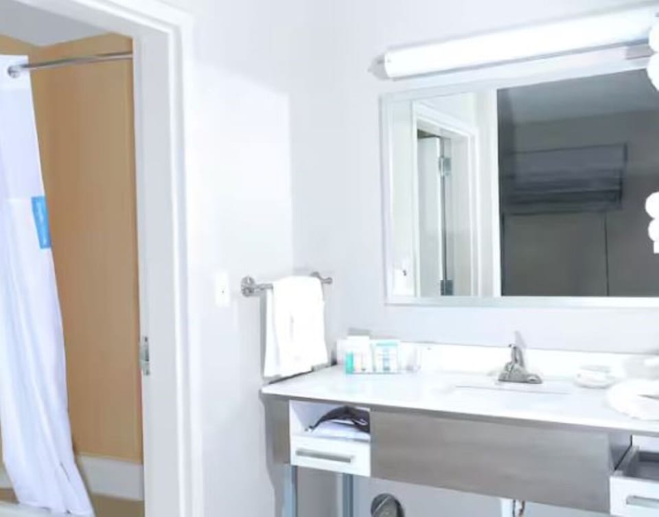 Get ready comfortably with a wide vanity and mirror.