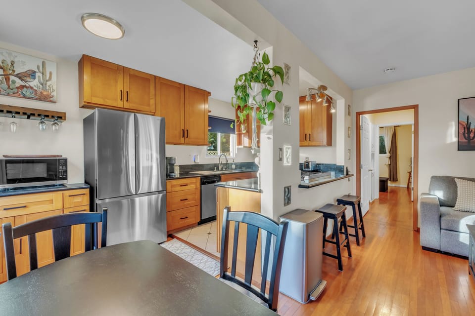 Double door fridge, microwave, dishwasher, gas cooktop stove and oven. 