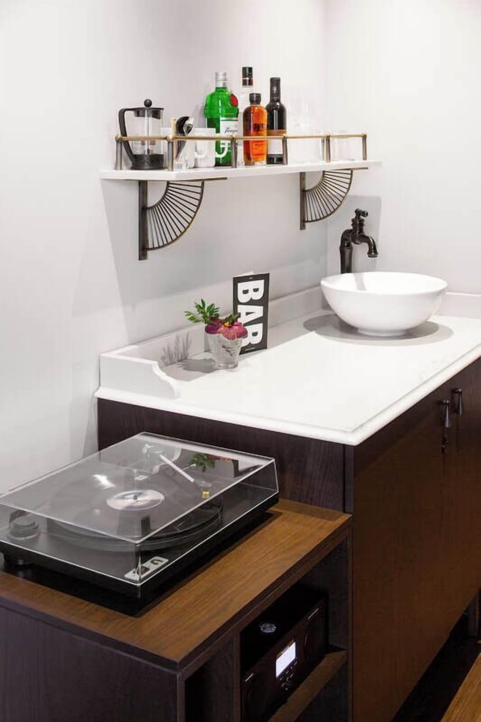 Mix cocktails at your private bar with sink and glassware.