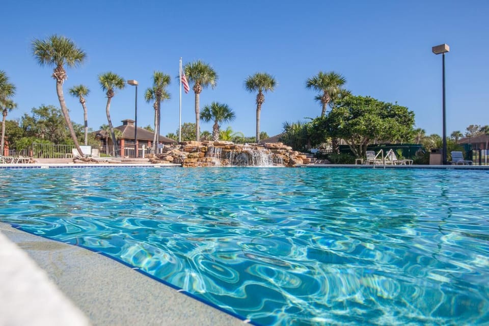 Dive into crystal-blue water under bright, cloudless skies.