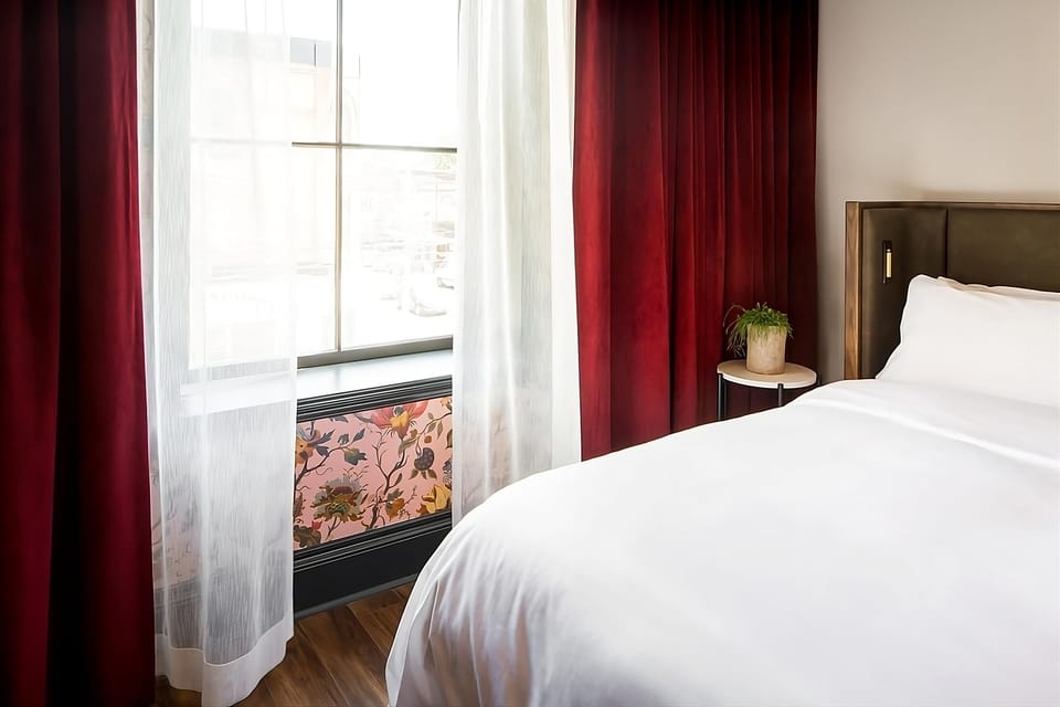 Wake refreshed beside crisp linens and dramatic velvet curtains.