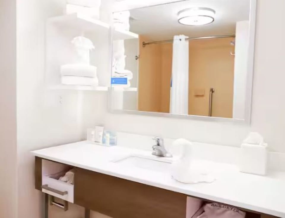 Get ready comfortably with a wide mirror and generous counter space.