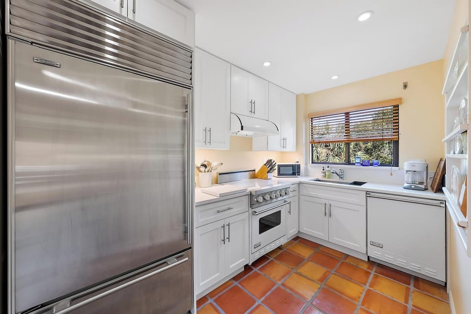      Subzero fridge, Viking appliances, vented range hood, large Franke sink. 