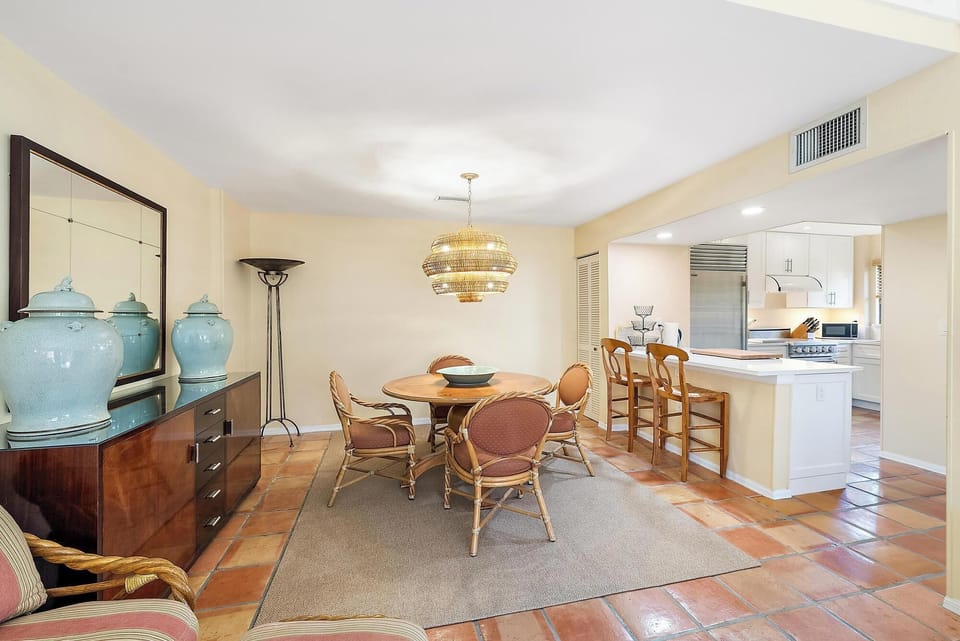 Curry and Company Antibes chandelier, McGuire twisted rattan chairs. 