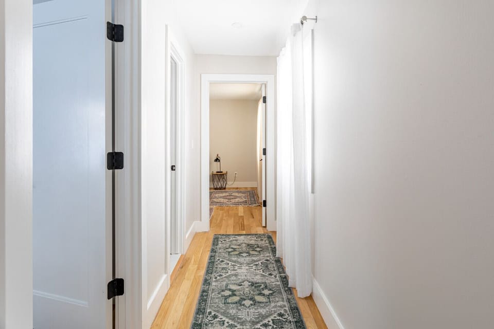 The main level includes a hallway leading to bedrooms and bathrooms
