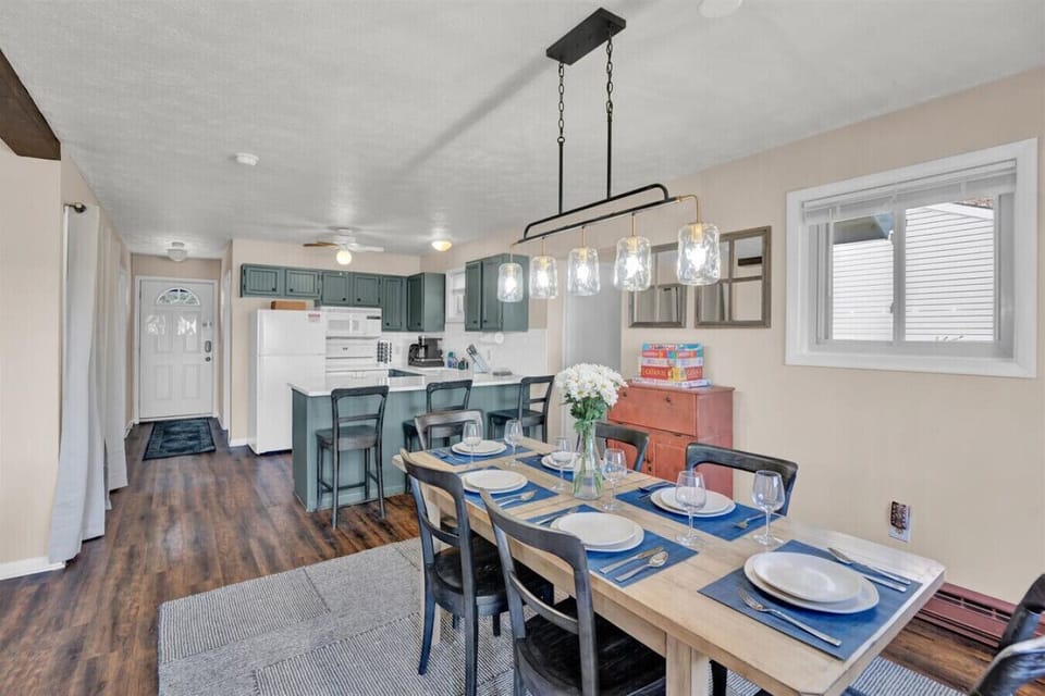 Spacious dining area with ample seating at the table, plus extra spots at the kitchen island—ideal for family meals or casual gatherings.