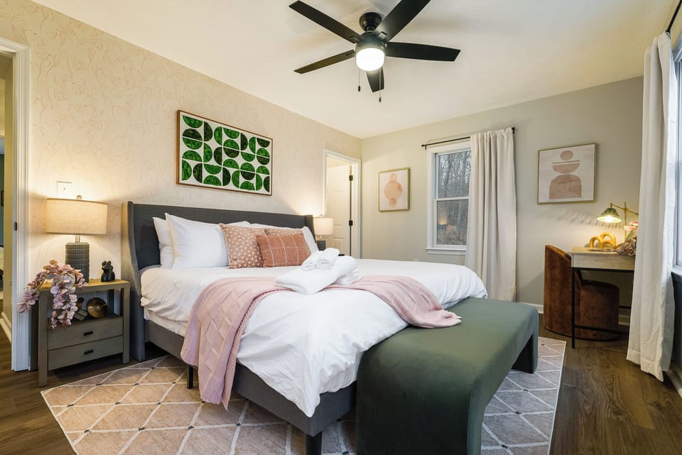 Master Bedroom with attached full bathroom, smart tv, and workstation
