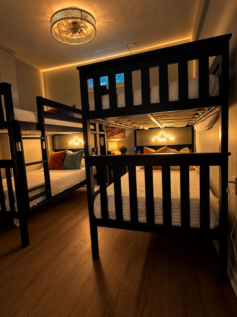 Cozy, modern bunk room with warm lighting—perfect for groups