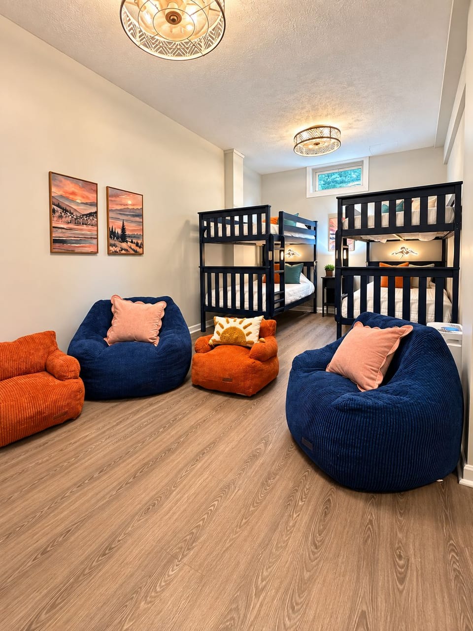 Fun bunk room with cozy bean bags, warm lighting, and space for the whole crew