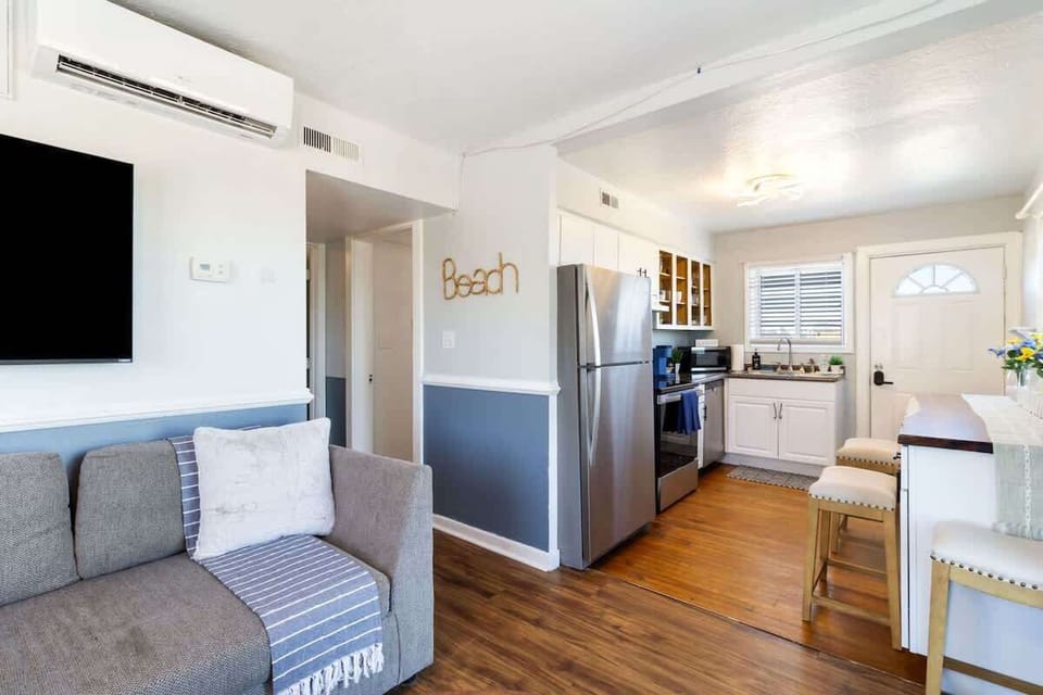 Open living area connecting seating, dining & kitchen spaces seamlessly