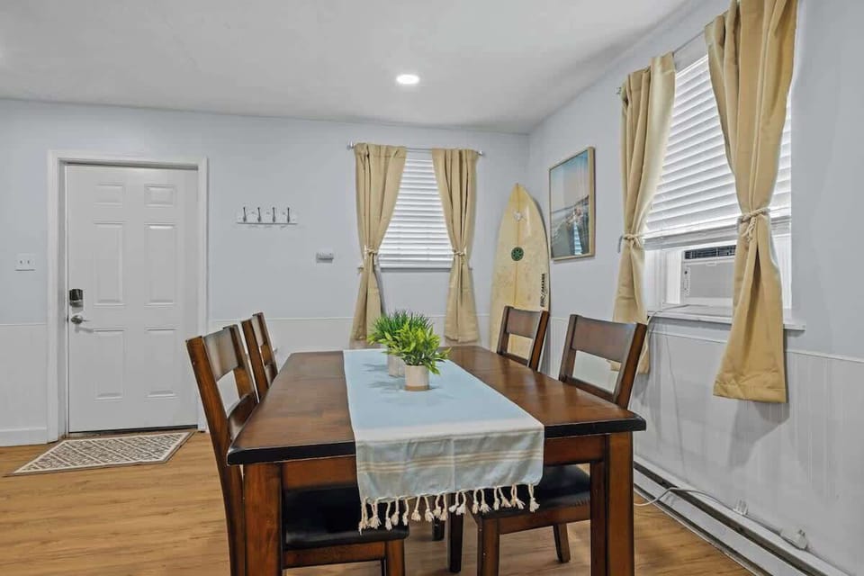 The cozy dining area seats four and sits by large windows for plenty of sunlight. It's perfect for family breakfasts or evening dinners after a beach day. 