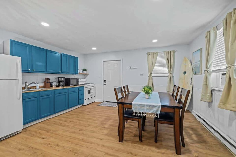 Bold blue cabinets and modern appliances make cooking a joy in this well-equipped kitchen. The space feels fresh, open, and full of natural light. 