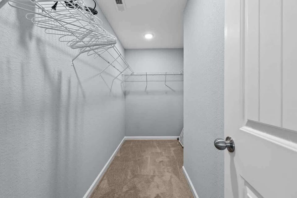 Large walk-in closet w/ built-in shelving & plenty of storage space
