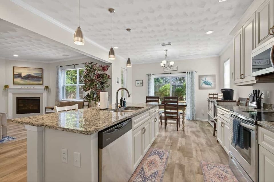 Kitchen view showing additional counter space, modern lighting, and direct access to the dining area.