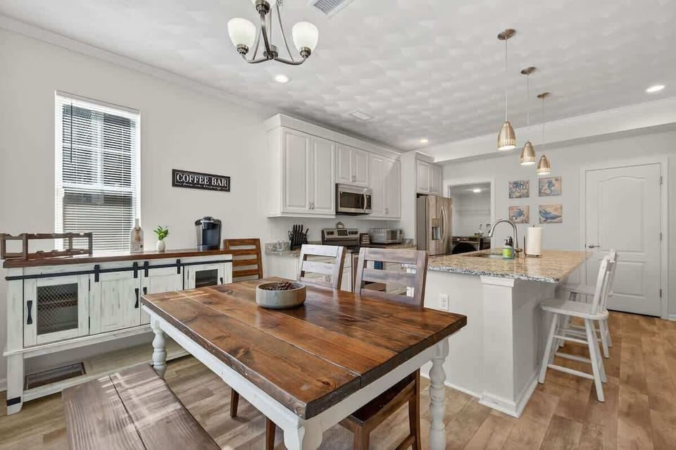 Open-concept kitchen and dining area with seating for group meals.