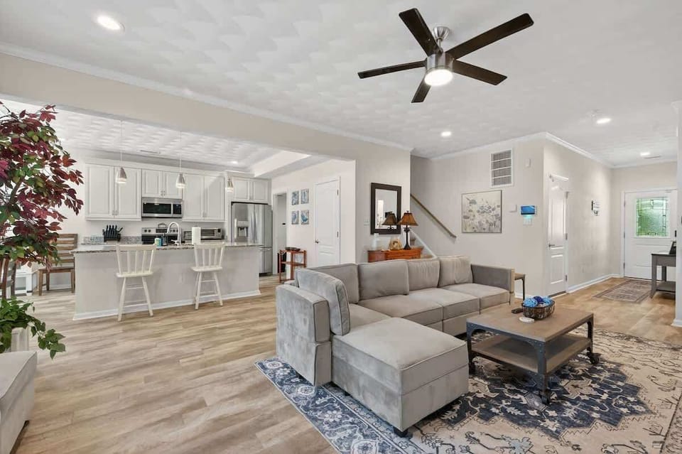 Open-concept living area with cozy furnishings and easy flow into the kitchen and dining spaces.