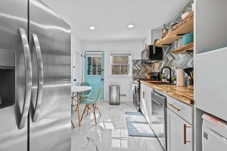 Sleek kitchen w/ stainless appliances, ample counter space & open flow