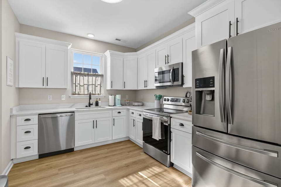 Whip up your favorites in this bright, modern kitchen with stainless appliances and crisp white cabinetry. It's the perfect blend of style and function for any length of stay. 