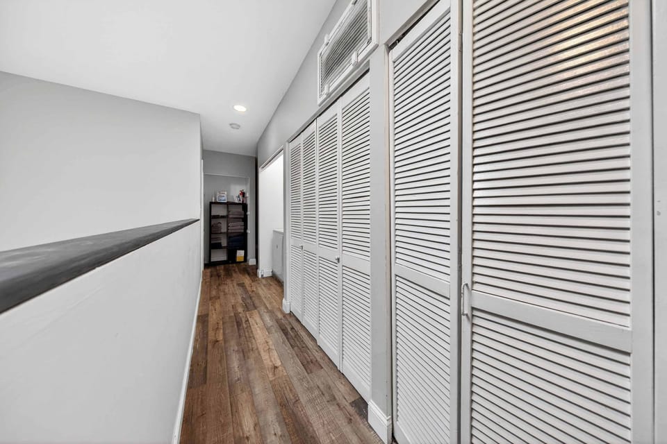 This stunning hallway, with its crisp white shutters and inviting wooden floors, creates a warm atmosphere that feels like home. Perfect for relaxation and adventure alike. 