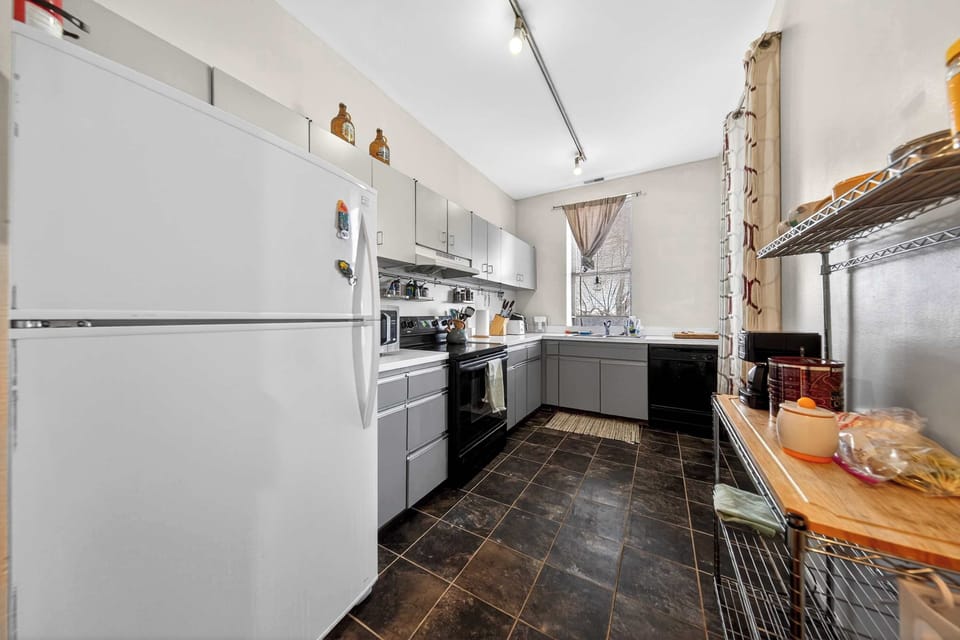 Discover the heart of your getaway in this sophisticated kitchen, complete with a stylish refrigerator, a high-performance stove, and a stunning oven. Perfect for crafting memorable meals and sharing laughter with loved ones.