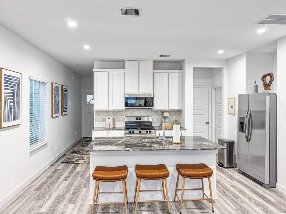 Fully equipped Kitchen with 3 bar stools for extra seating in open area combined with Livingroom and Diningroom.