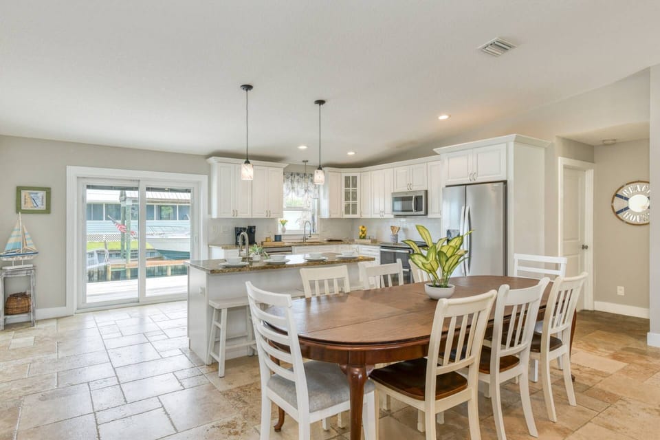 The large dining table with seating for 8-10 is perfect for enjoying meals and time together.