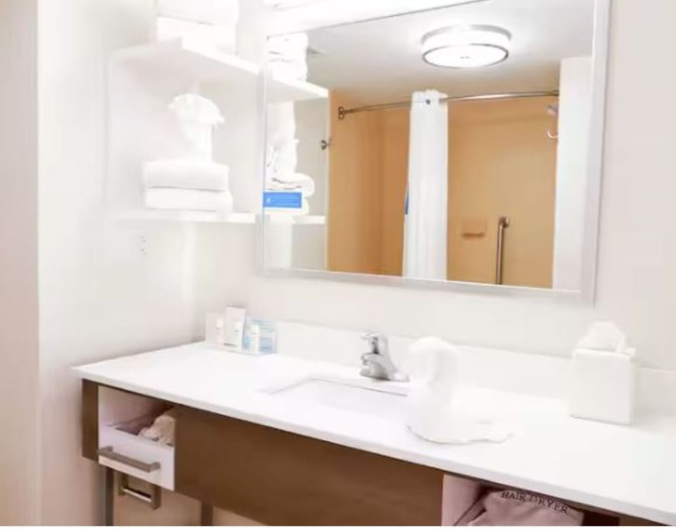 Get ready comfortably with a wide mirror and generous counter space.