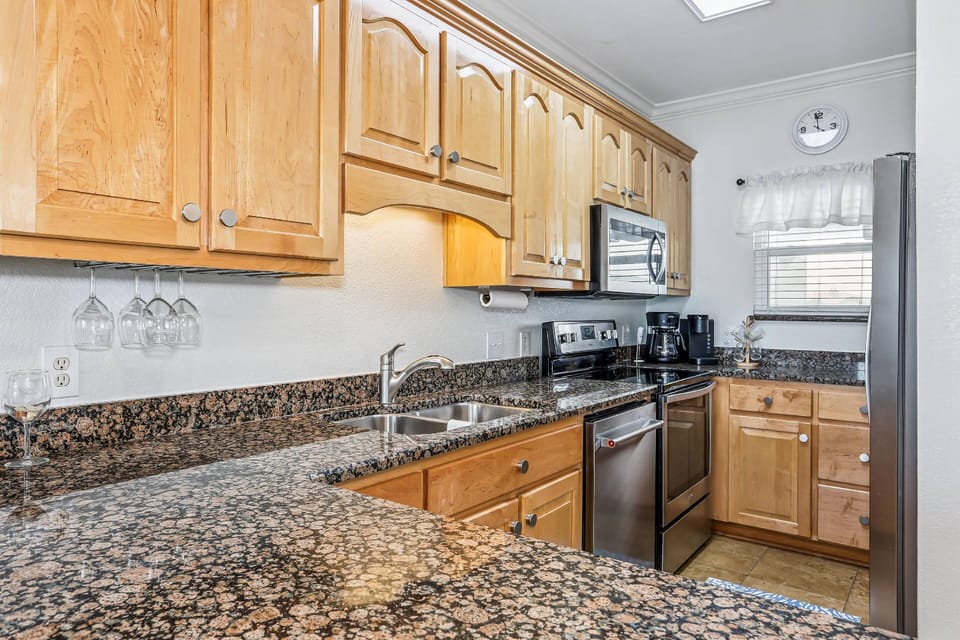 Fully equipped kitchen with stainless appliances and granite counters