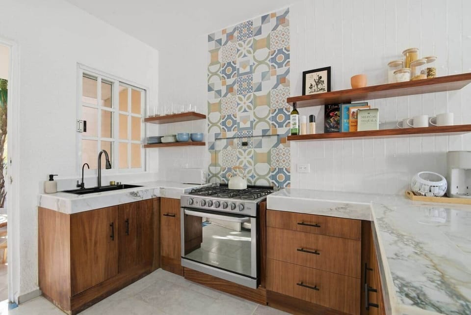 Fully equipped kitchen with refrigerator, microwave, stove, oven, coffee machine, toaster, and everything you need to prepare and enjoy home-cooked meals.